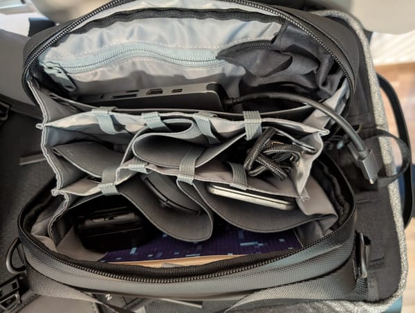 an open bag of electronics, slightly raided as the photo is taken mid-conference